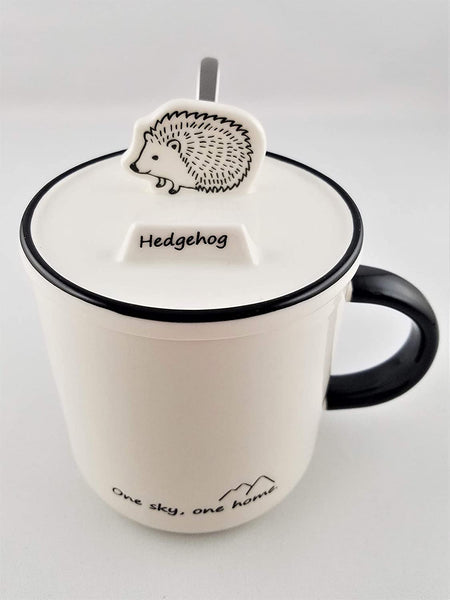 Ceramic mug with animal shaped phone stand on lid
